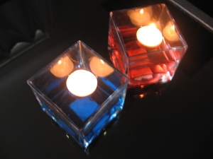 overhead of floating tealights in colored water